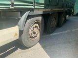a green truck that is parked on the side of the road