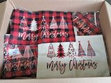 boxes filled with red and black plaid christmas decorations sitting on top of a table