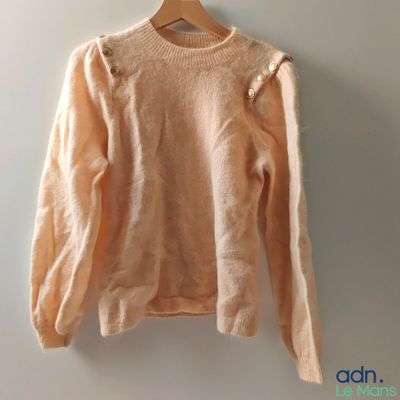 an image of a sweater hanging on a hanger