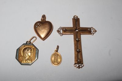 three pieces of jewelry including a cross, a heart, and a medal