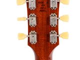 a close up of a guitar neck with four heads