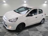 a picture of a small white car parked in a garage