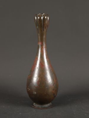 a brown vase that is sitting on a table