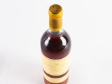 bottles of wine are lined up on a white surface