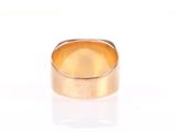 a close up of a gold ring on a white surface