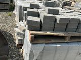 a pile of bricks sitting on top of a pile of pallets