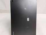 the back of a black laptop computer sitting on top of a white surface