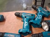 five electric tools that are sitting on a table