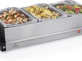 an image of a buffet with three trays of food on top of it
