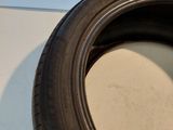 a close up of a tire on a white surface