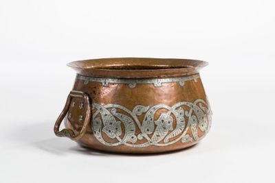a copper pot with a handle on a white background