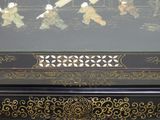 a black and gold box with a picture of a group of people on it