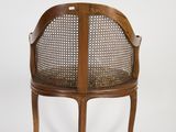 an image of a wooden chair with a cane back and cane legs