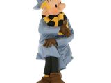 figurine of a man in a blue coat and hat sitting on a chair