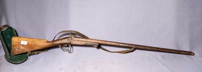 an old rifle with a wooden barrel and a green case