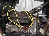 a close up view of a car engine with a hose connected to it