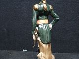 a figurine of a woman in a green dress and hat
