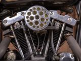 a close up view of a motorcycle engine with a clock on it