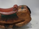 a wooden horse with a saddle on it ' s back