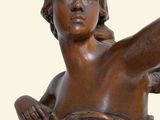 statue of a woman holding a tennis racquet in her right hand