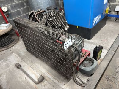 a blue air compressor sitting on the floor next to a blue machine