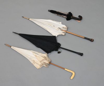 Plusieurs parapluies sont alignés les uns à côté des autres sur une surface grise