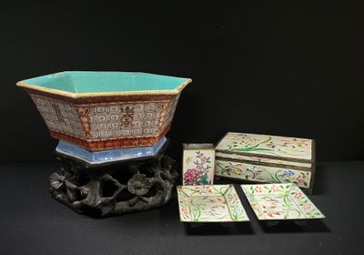 a small bowl sitting on top of a table next to a box