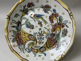 a close up of a plate with flowers and birds on it