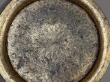 two silver trays sitting on top of a table next to each other