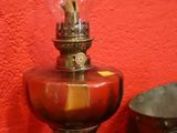 a clock and a lamp on a table with a red wall