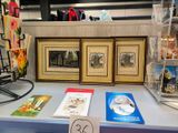 three framed pictures on a table with a price tag