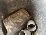 a metal bucket with some pipes inside of it
