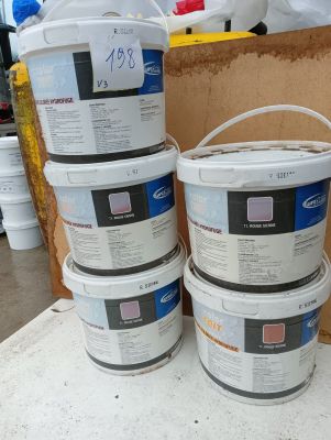 several buckets of paint sitting on top of a table next to a cardboard box