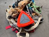 a pile of shoes on the ground next to a skateboard