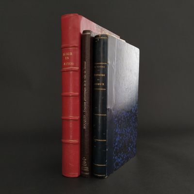 two books sitting on top of each other on a black surface