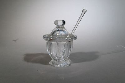 a glass jar with a spoon in it on a table