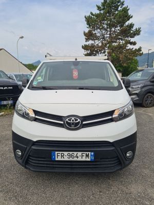 the front of a white van parked in a parking lot