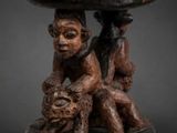 a close up of a wooden table with a monkey on it