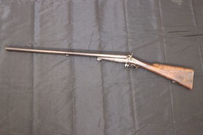 the rifle is laying on the table ready to be used
