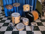 a drum set that is sitting on a checkered floor