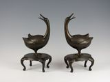 pair of bronze birds on stools with legs and feet