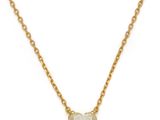 a gold necklace with a heart shaped stone on a chain