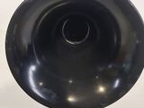 a black vase that is sitting on a white table