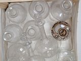 many empty glass bottles in a wooden box on the floor