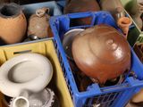 many pots and containers that are sitting on the floor