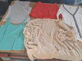 a pile of clothes sitting on top of a wooden table