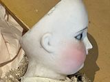 two dolls that are sitting next to each other on a table