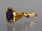 an image of a gold and amethorate pendant with a purple stone