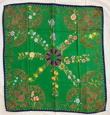 an image of a green scarf with a blue border and flowers on it
