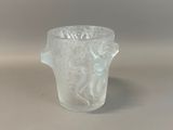 a glass vase with a design on it on a table